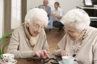 Two Senior Women Playing Dominos